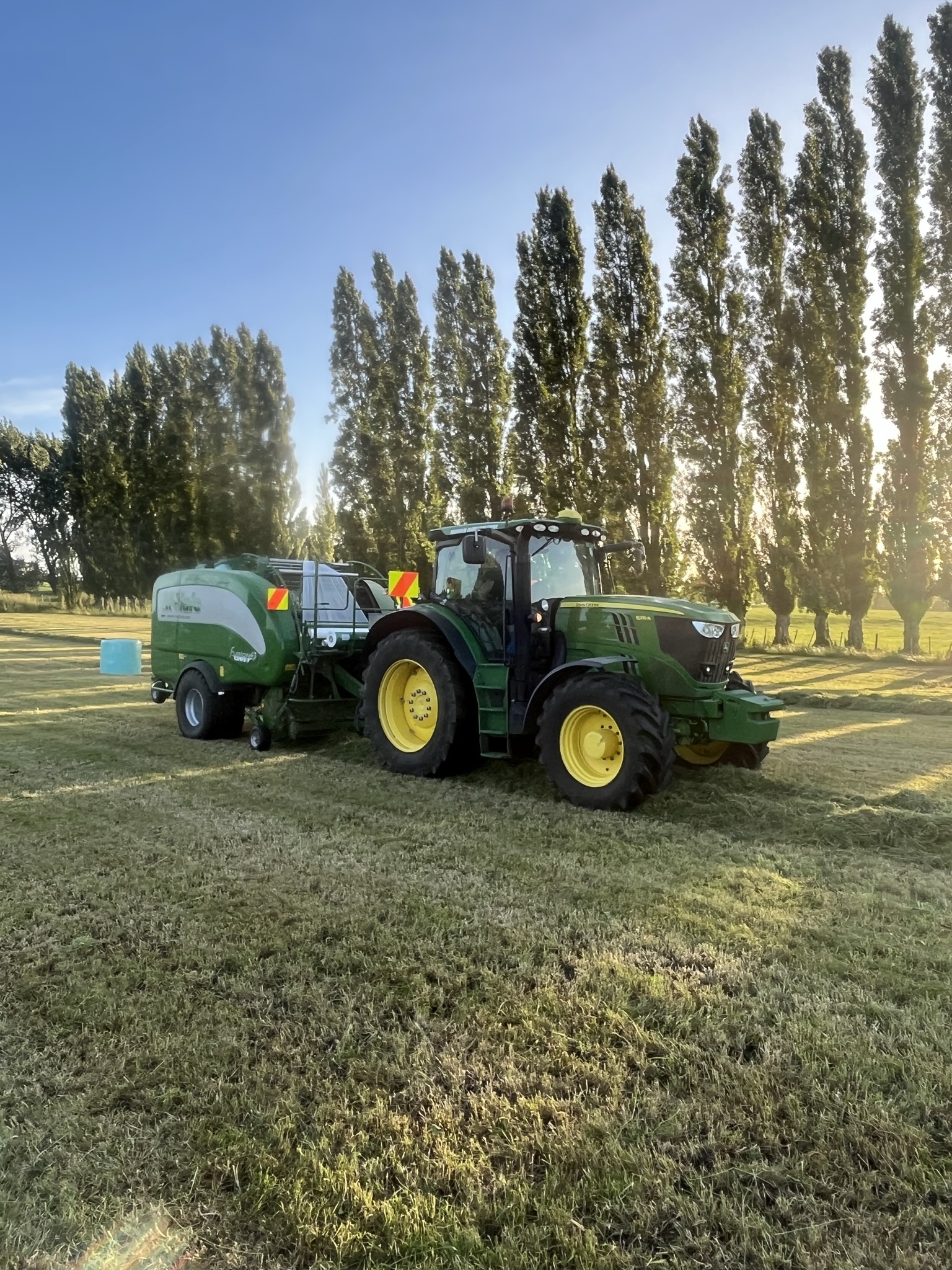 Arnold Agriculture tractor and baler at work in the paddock