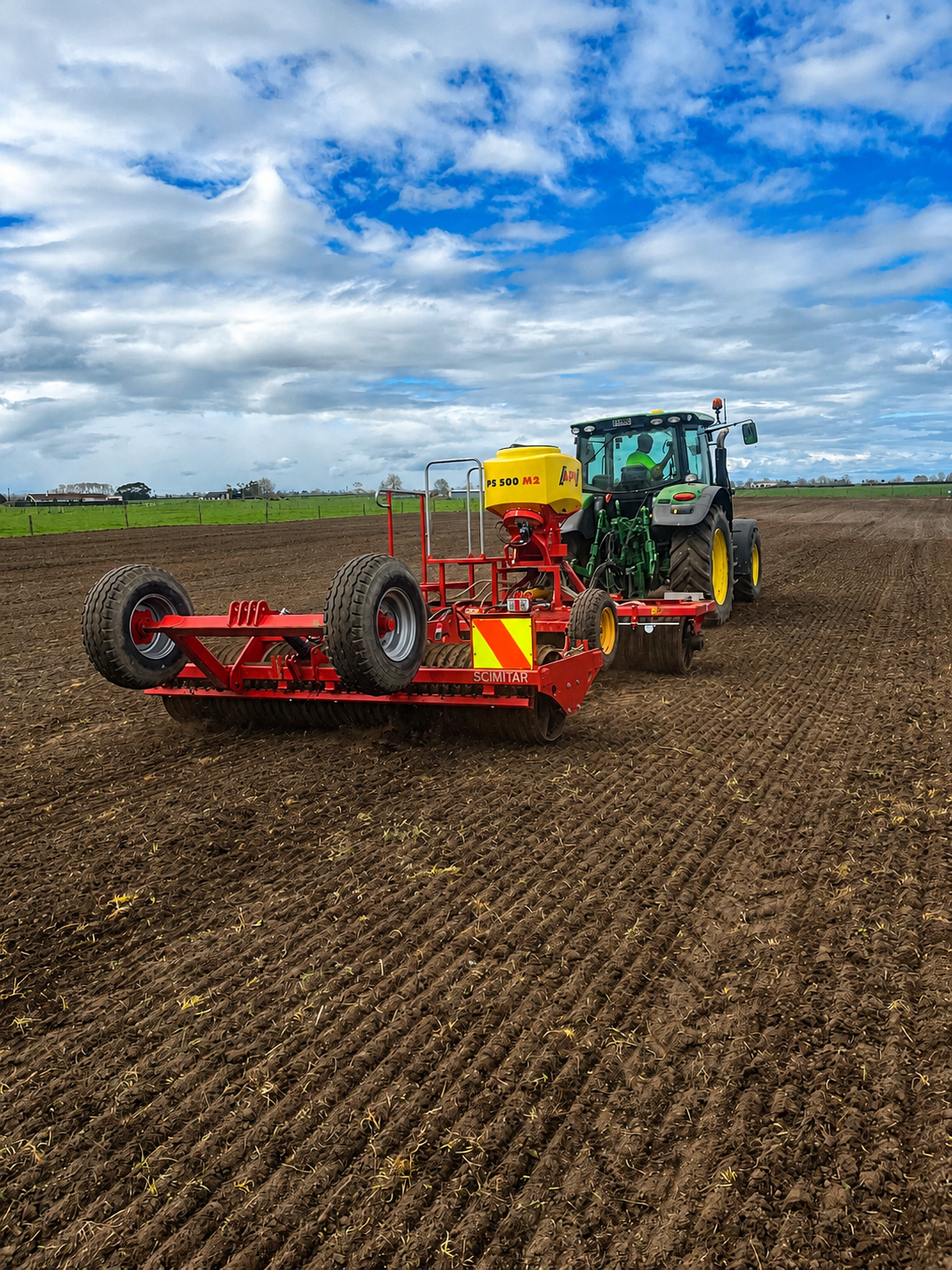 Tractor rolling and seeding a cultivated seedbed